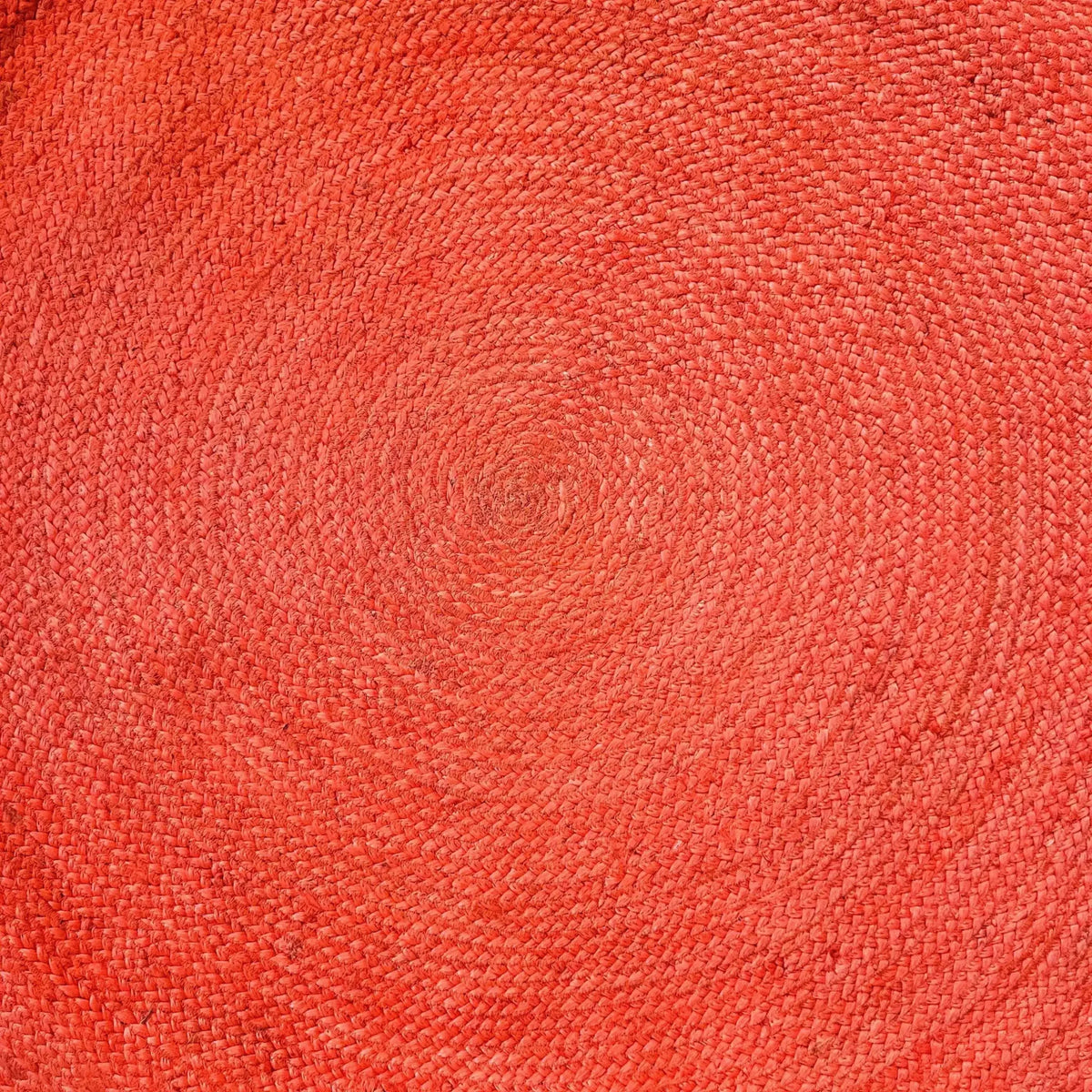 Top view of a vibrant red classic circles round jute rug, perfect for adding a pop of color to your living room or bedroom. This 9' x 9' area rug features a tightly woven texture, ideal for spaces seeking a touch of natural charm, resembling living room rugs 8x10 or bedroom area rugs.