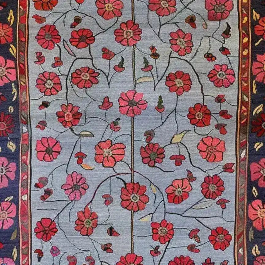 A vibrant Red Velvet Bloom Hand Knotted Area Rug, showcasing a stunning floral pattern with red flowers on a soft blue background. This vintage rug is perfect for adding a touch of elegance to your living room, especially in an 8x10 layout. The intricate design resembles Persian rugs, offering a classic and timeless appeal.