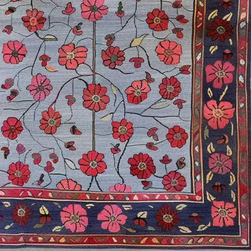 A detailed view of the Red Velvet Bloom Hand Knotted Area Rug, showcasing its intricate floral design. Perfect for adding a touch of elegance to any living room, this 8x10 vintage rug features vibrant red and pink blossoms on a classic Persian-style background.