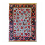 The Red Velvet Bloom Hand Knotted Area Rug showcases a vintage Persian design with vibrant floral patterns. Perfect for adding elegance to living rooms, this 8x10 area rug features intricate red and pink flowers on a subtle background, bordered by a rich, decorative frame.