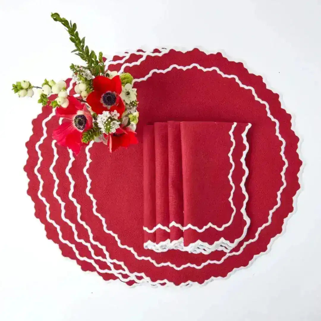 Red & White Delight Placemats fanned flat-lay — solid red oval with white crochet zigzag trim and matching red napkins