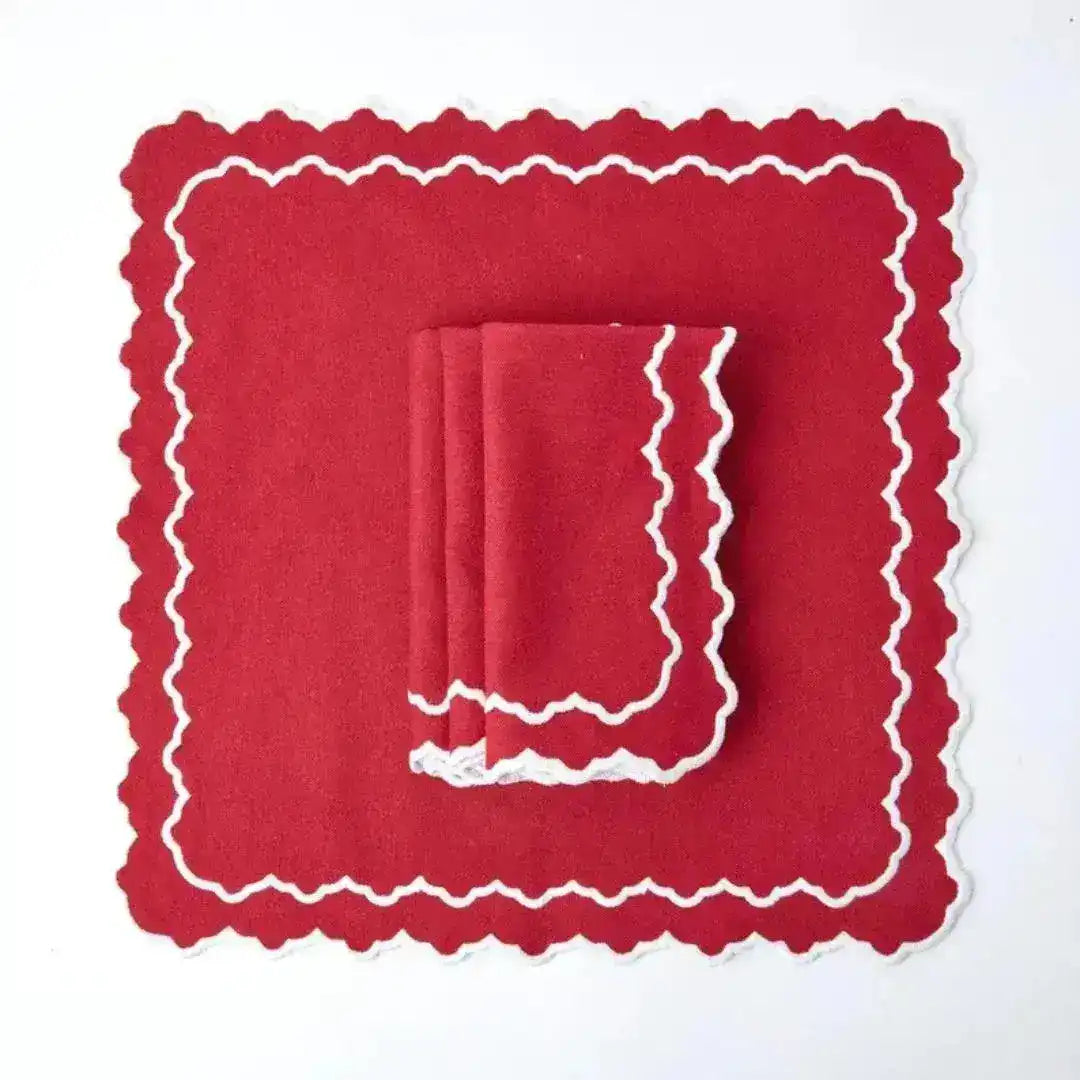Red & White Delight Placemats flat lay — square red placemat with white crochet zigzag border and matching folded red napkin