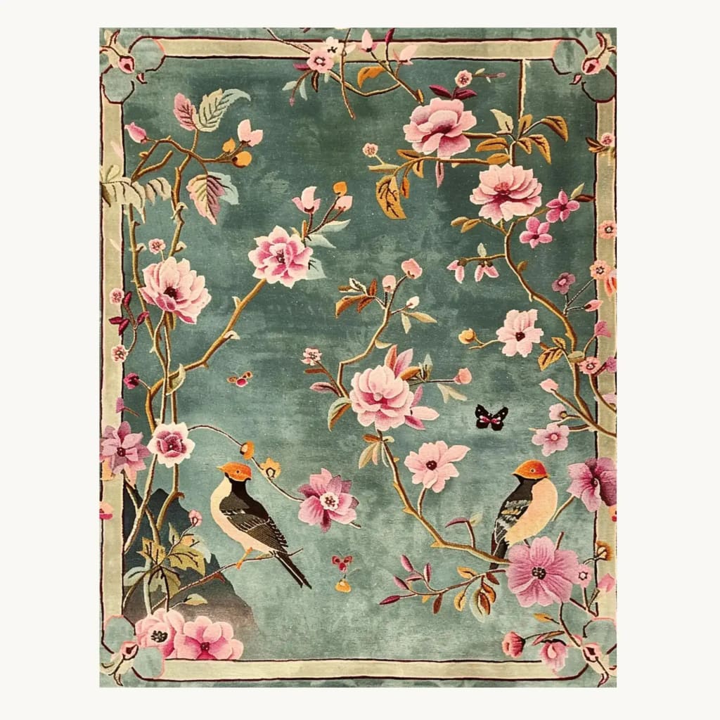 The Regal Aviary Frame Hand Tufted Rug is a stunning area rug featuring a vibrant floral design with birds perched among blossoms on a lush green background. Perfect for adding elegance to living rooms or offices, this wool rug combines style and comfort, making it an ideal choice for area rugs in living spaces.