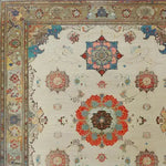 A close-up view of the Regal Blossom Medallion Hand Knotted Area Rug, showcasing its intricate vintage design with floral medallions in vibrant hues. Perfect for adding a touch of elegance to large living rooms, this Persian-inspired rug exemplifies timeless beauty and craftsmanship.