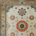 A close-up view of the Regal Blossom Medallion Hand Knotted Area Rug, showcasing its intricate vintage design with floral medallions in vibrant hues. Perfect for adding a touch of elegance to large living rooms, this Persian-inspired rug exemplifies timeless beauty and craftsmanship.