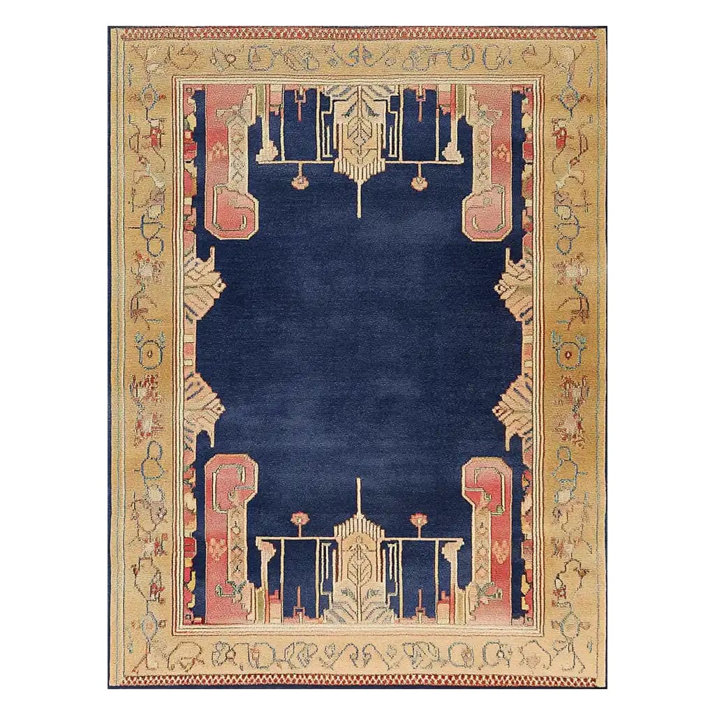 A beautifully designed area rug featuring a bold navy center surrounded by an intricate border in warm beige and pink tones. This contemporary wool rug is perfect for adding a touch of elegance to any living room. Ideal as an 8x10 living room rug, it showcases a blend of traditional and modern design elements.