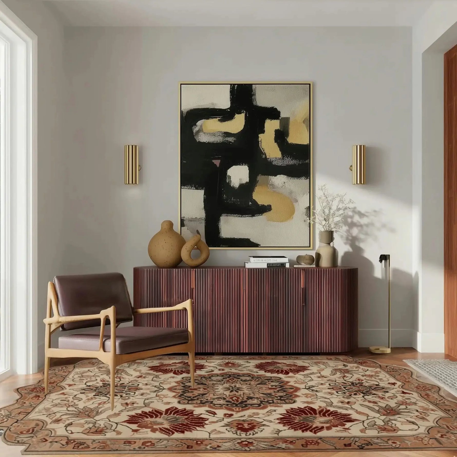 A cozy living room featuring a Regal Petal Hand-Tufted Area Rug with intricate vintage patterns, crafted from high-quality wool. This large living room rug adds warmth and elegance, complementing the modern decor with a wooden chair and abstract wall art.