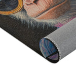 Corner of Regal Rebel Couture Monkey Accent Rug curled showing dark-background monkey portrait print and gray non-slip backing with serged zigzag edge