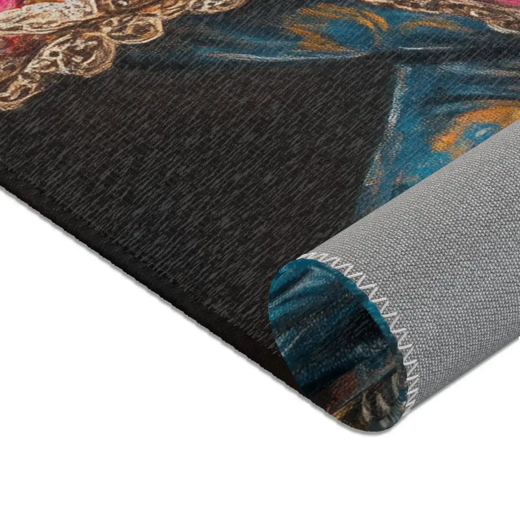Rolled corner of the Regal Renaissance Chihuahua rug showing dark charcoal surface with blue floral jacket edge and grey non-slip backing with zigzag seam