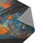 Folded corner of the Regal Renaissance Chihuahua rug showing blue floral coat with orange motifs on dark background and grey non-slip backing