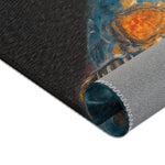 Rolled bottom edge of the Regal Renaissance Chihuahua rug showing dark charcoal background with blue jacket and orange floral motif and grey non-slip backing