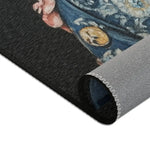 Rolled long side of Regal Renaissance Pup Couture Dog Art Accent Rug showing charcoal face dark blue brocade jacket button and grey backing seam