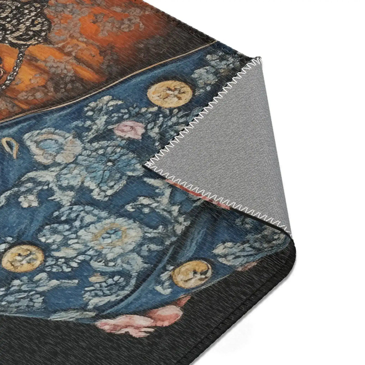 Corner fold of Regal Renaissance Pup Couture Dog Art Accent Rug revealing blue floral brocade jacket with gold coin buttons and grey anti-slip backing