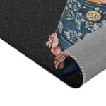 Rolled corner of Regal Renaissance Pup Couture Dog Art Accent Rug showing dark charcoal face blue brocade jacket detail and grey backing