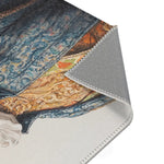 Corner fold of Regal Reptile Renaissance Rug showing blue brocade coat and gold ornamental details with ruffled collar and gray backing