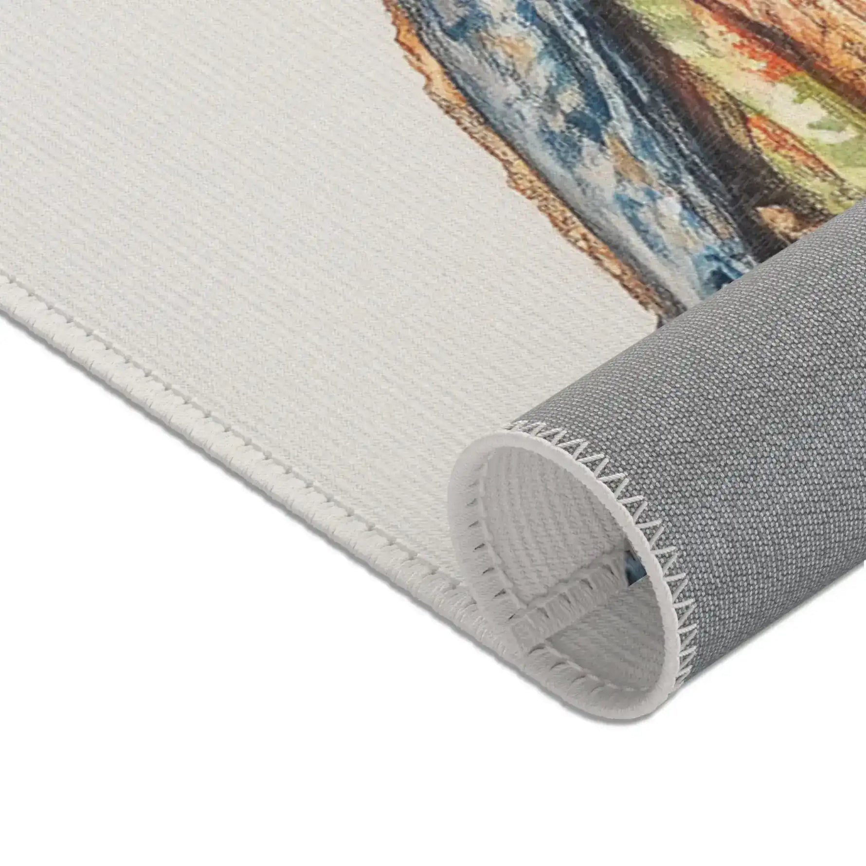 Rolled edge corner of Regal Reptile Renaissance Rug showing cream face side with vibrant colorful print visible and gray backing