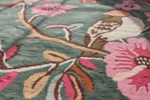Tufted rug close up shot green floral bird rug