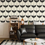 Repeating Black Heron crane wallpaper above wainscoting in a lounge with black leather sofa