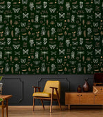 Retro botanical insect lattice wallpaper over dark wainscot with yellow chair and walnut sideboard