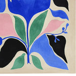 A vibrant and contemporary wool area rug featuring an abstract floral design in blue, green, pink, and black. Perfect for adding a pop of color to living room area rugs, this hand-tufted rug enhances any modern space with its bold and artistic pattern.