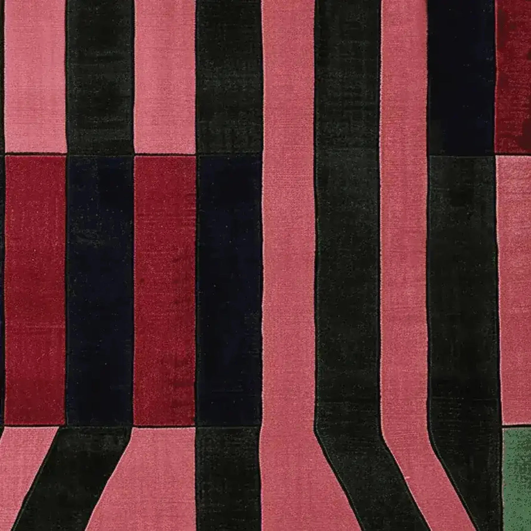 A vibrant area rug featuring bold vertical stripes in shades of red, pink, and black. This contemporary rug, made from high-quality wool, is perfect for adding a stylish touch to any living room. Ideal as a large living room rug, its 8x10 size offers ample coverage and a modern aesthetic.