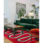Stylish Retro Red Snake Hand Tufted Wool Rug in a cozy living room setting. The rug adds a vintage charm with its striking snake design, complementing the lush green sofa and wooden coffee table. Ideal for large living rooms or formal dining rooms, this wool area rug brings a touch of elegance and warmth to your home decor.