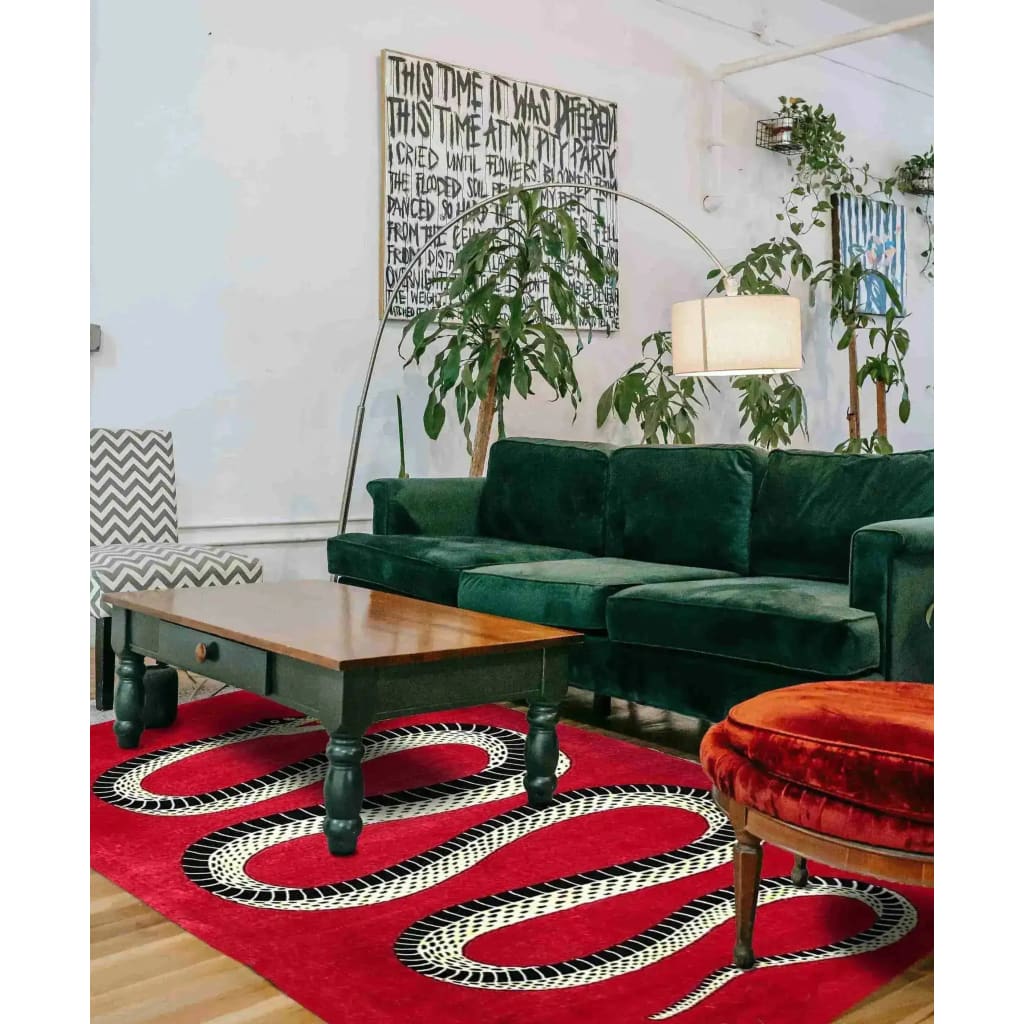 Stylish Retro Red Snake Hand Tufted Wool Rug in a cozy living room setting. The rug adds a vintage charm with its striking snake design, complementing the lush green sofa and wooden coffee table. Ideal for large living rooms or formal dining rooms, this wool area rug brings a touch of elegance and warmth to your home decor.