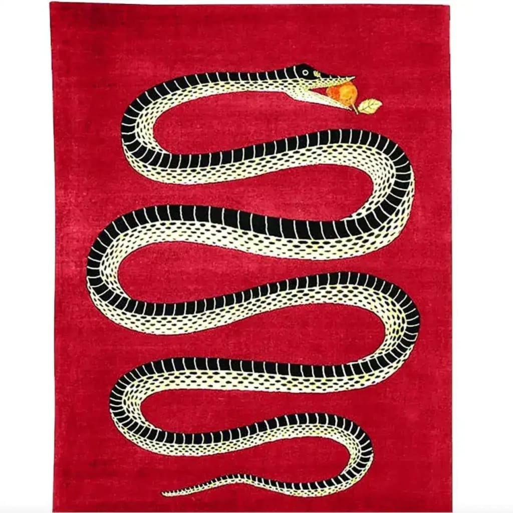 A striking Retro Red Snake Hand Tufted Wool Rug featuring a bold black and white snake design on a vibrant red background. Perfect for adding a vintage touch to a dining room or as a statement area rug in a large living room. This wool rug combines style and texture, ideal for both living rooms and formal dining rooms.