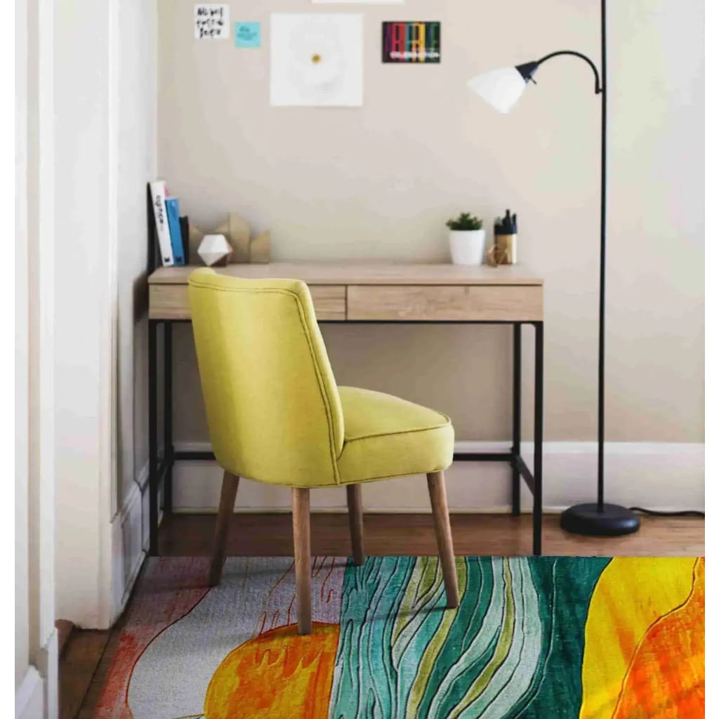 A vibrant Retro Seaside Oasis Hand Tufted Area Rug displayed in a cozy bedroom setting. This contemporary rug, made of high-quality wool, adds a splash of color with its abstract design featuring waves of green, yellow, and orange. Positioned under a stylish yellow chair and a minimalist desk, it enhances the modern aesthetic of the room, making it ideal for both bedroom and office spaces.