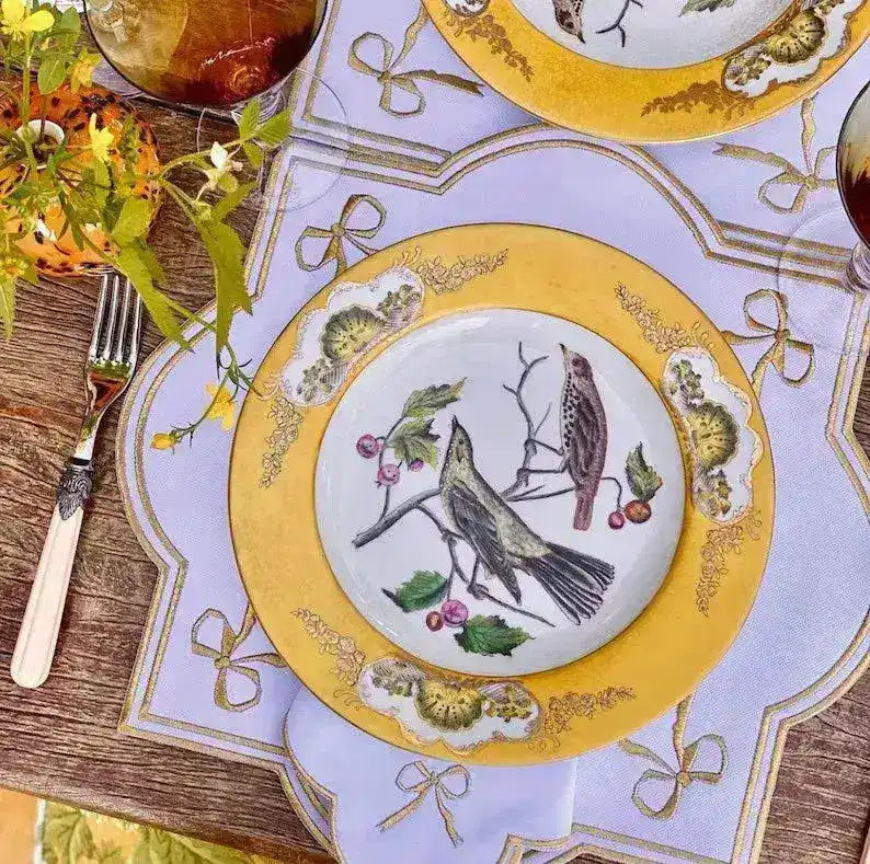 ribboned radiance placemat white lilac gold ribbon bow embroidery border yellow bird plate antler cutlery rustic wood table