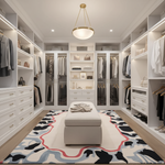 Modern walk-in closet with white shelves, clothes, and a patterned rug.