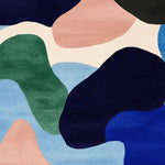 Discover the Riverstone Drift Dream Hand Tufted Rug, a contemporary square area rug perfect for your living room. This 8x10 wool rug features a vibrant abstract design with rich colors of green, blue, and peach, making it an ideal choice for modern decor enthusiasts. Elevate your space with this stylish and cozy addition to your collection of rugs for living room.