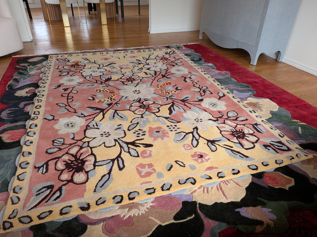 Floral patterned rug on a wooden floor