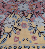 Floral patterned rug with a mix of colors on a yellow background