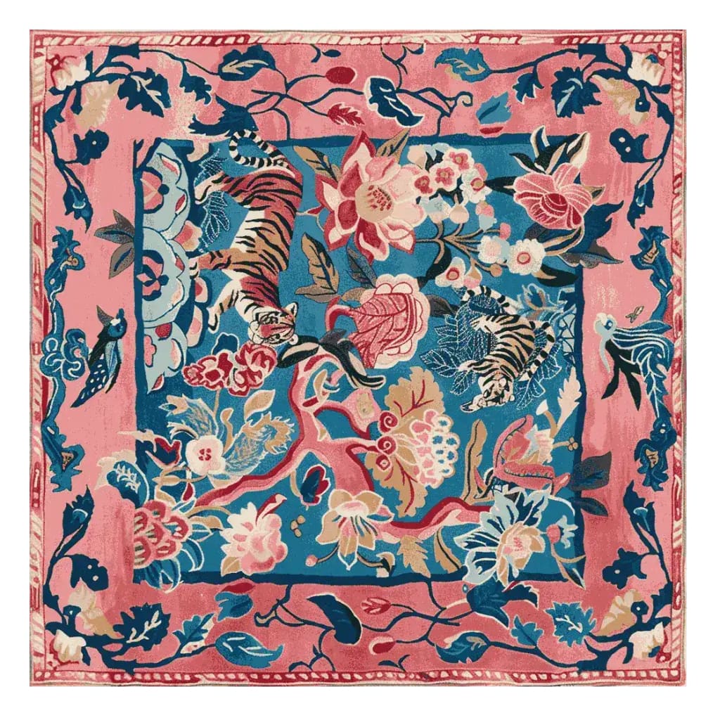 Vibrant hand-tufted wool area rug featuring an abstract design with tigers, flowers, and foliage in bold pink and blue colors. This large square rug is perfect for enhancing the decor of a living room, offering a luxurious and artistic touch.
