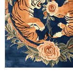 A vibrant area rug featuring an abstract design with two tigers surrounded by large floral patterns on a deep blue background. Perfect for large living room spaces, this hand-tufted wool rug combines vintage elegance with a modern flair, ideal for those seeking an 8x10 living room rug that adds a touch of nature-inspired artistry.