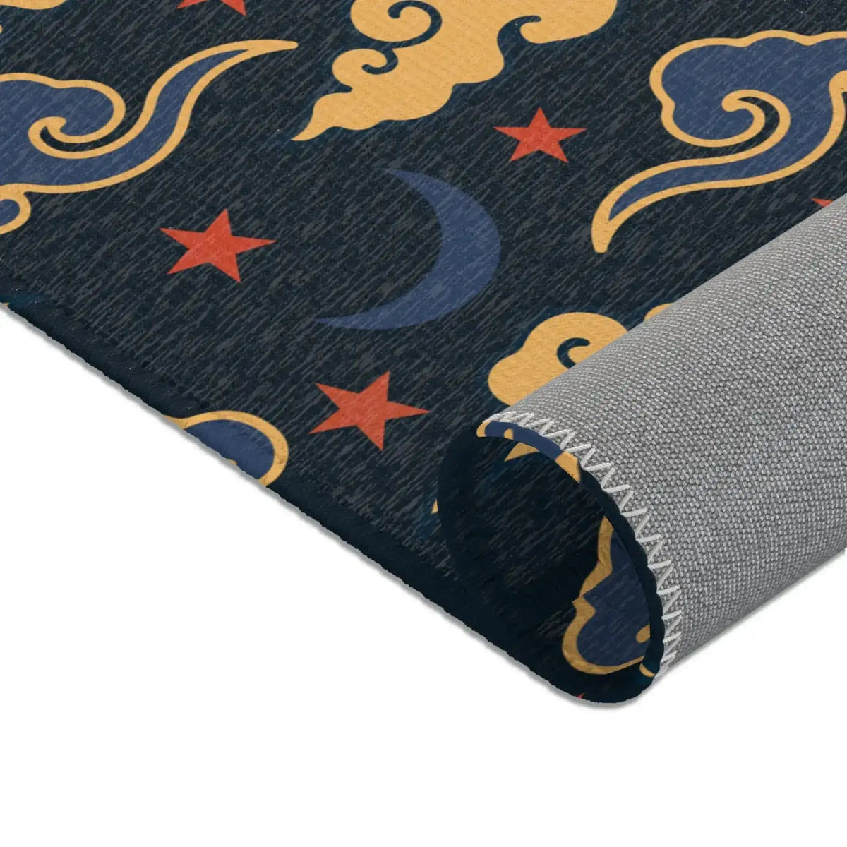 Rolled edge of the Retro Night Sky Accent Rug showing blue crescent moons, red stars and gold clouds