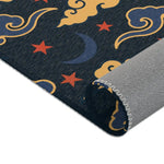 Rolled edge of the Retro Night Sky Accent Rug showing blue crescent moons, red stars and gold clouds