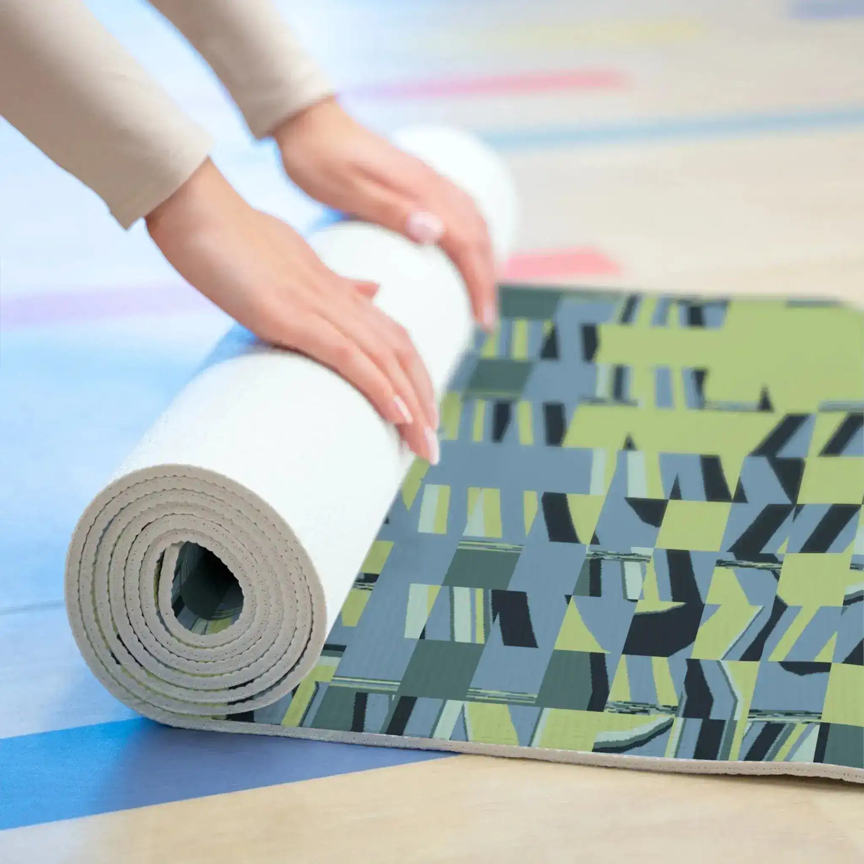 Rolling up Pixel Wave mat on wood floor, patterned top and white underside