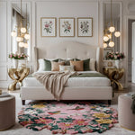 Luxurious bedroom with a large bed, floral rug, and decorative lighting.