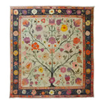 A beautifully hand-knotted area rug featuring a vibrant floral design, perfect for adding a touch of elegance to any living room. This Roots and Branches Tapestry showcases intricate patterns reminiscent of classic Persian rugs, making it an ideal choice for those seeking unique living room area rugs.