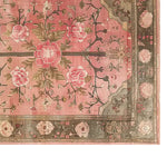 The Rosaire Grandeur Knotted Wool Area Rug showcases a stunning floral design, perfect for adding elegance to any living room. The rug features intricate patterns of blooming flowers in soft, warm tones, creating a cozy and inviting atmosphere.