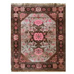 A beautifully crafted Rosé Reverie Knotted Wool Area Rug, showcasing a stunning floral pattern with shades of pink and brown. Perfectly suited for large living rooms, this floral rug brings an elegant touch to any space.