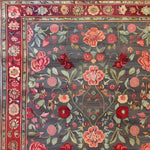 A beautifully detailed hand-knotted area rug featuring an intricate floral pattern with roses and lilies, perfect for adding a vintage touch to large living room spaces. This Persian-style rug showcases vibrant red and pink floral designs set against a muted backdrop, ideal for those seeking elegant area rugs for their living room.