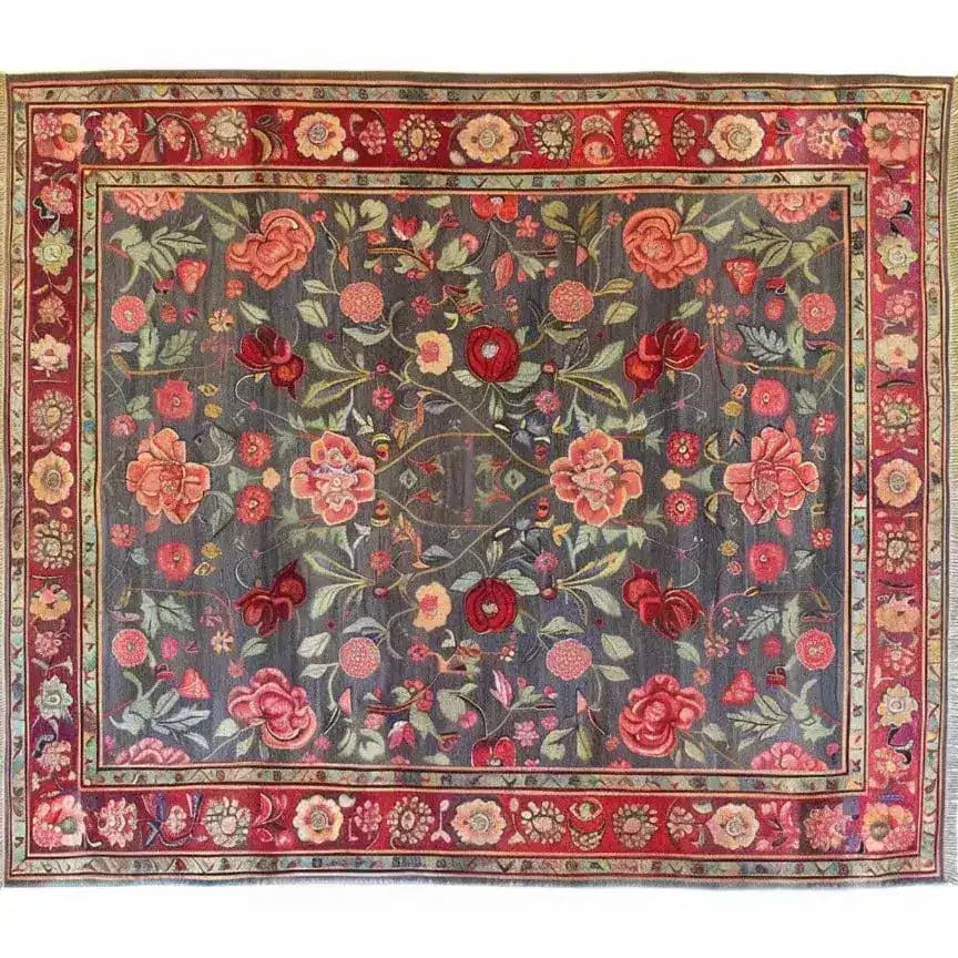 This beautiful hand-knotted area rug features a vibrant floral design with roses and lilies, ideal for large living rooms. The vintage rug's intricate patterns and rich colors evoke the elegance of Persian rugs, making it a stunning addition to any living space.