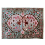 Elegant area rug featuring a vibrant floral design with roses and vines in rich hues. Perfect for living room decor, this 8x10 wool rug brings a touch of nature-inspired beauty to any space.