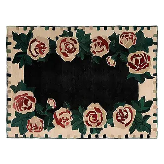 The Rosette Noir Hand Tufted Rug showcases a striking floral design with large roses encircling a deep black center. This elegant area rug, crafted from wool, is perfect for adding a touch of sophistication to living rooms or offices, making it an ideal choice for those seeking floral rugs or wool rugs that enhance any space.