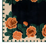 A stunning area rug featuring a hand-tufted floral design in vibrant orange and green hues. This wool rug, perfect for living room area rugs, showcases intricate rose patterns against a contrasting dark background, adding elegance and warmth to any space.
