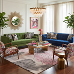Modern living room with a contemporary pink wool rug, green sofa, blue sofa, and colorful decor