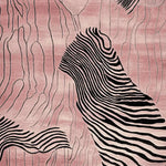 This Rosy Desert Drift Lines Hand Tufted Rug is a contemporary area rug featuring an abstract design with flowing black lines on a soft pink background. Made from high-quality wool, this rug is perfect for adding a modern touch to your living room. Ideal for those seeking stylish and durable area rugs for living room decor.